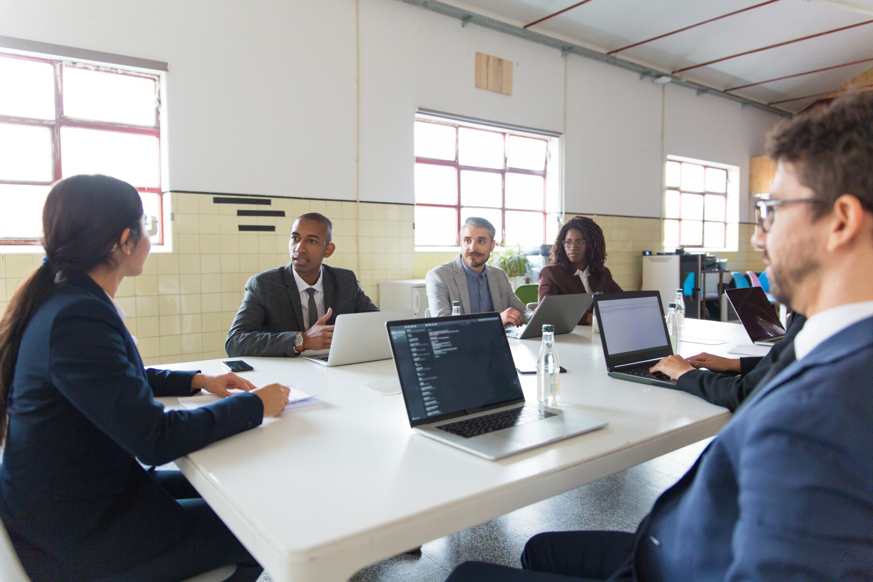 Team discussing project information in a meeting room