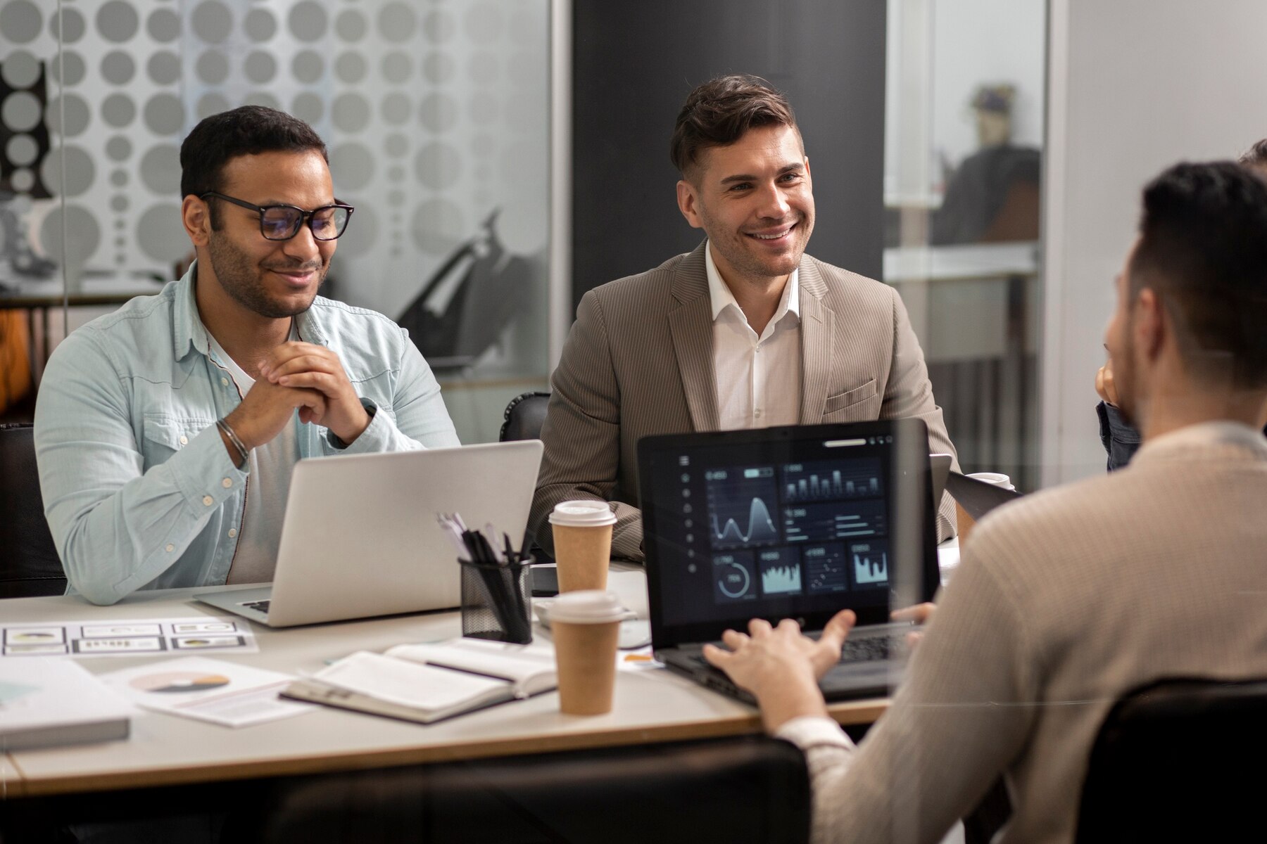 Team members discussing a digital product around a table
